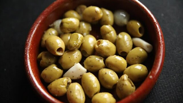 Mediterranean olives with garlic snack aperitif fresh tasty food dish delicious gourmet food background on the table rustic food top view copy space keto and paleo diet Vegetarian and vegan food