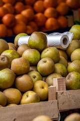 Apples and oranges displayed on a market stall