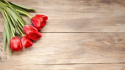 Fototapeta premium Elegant Red Tulips on Wooden Surface with Natural Background Elements