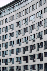 Close-up of a residential building showcasing a grid-like arrangement of windows and contemporary minimalist architecture.