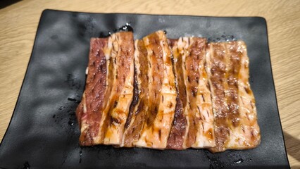 Korean style grilled beef on a black plate