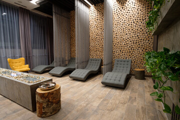 Relaxing spa lounge with comfortable loungers and wood accents