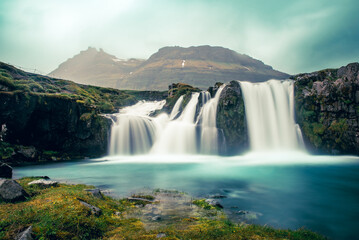 View to the Kirkjufell waterfall at summer. Kirkjufellsfoss waterfall, Iceland, Europe.
