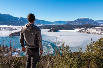 Hiker man on top of Taborhoehe viewing platform in Carinthia, Austria, Europe. Surrounded by high...