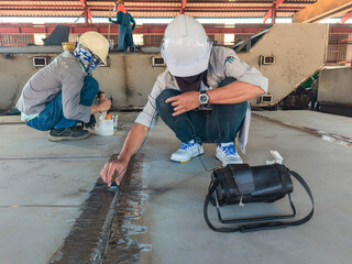 Inspectors are Checking Defects in Welded Steel Plate add joints with process Ultrasonic testing (UT) of Non-Destructive Testing(NDT) at the Industrial Factory.
