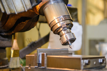 The angular milling process on NC milling machine with chamfer tools.