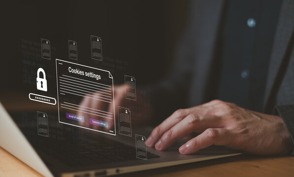 hand using laptop while choose to accept internet cookies policy or reject. Customer data privacy concept that allow web browser to collect user data to resell or use for marketing purpose.