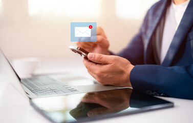 Hand of A Businessman using mobile phone open an email with sign reminder for unread emails for...