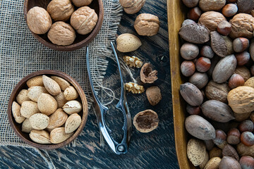 Assorted nuts in a wooden bowl. Top view