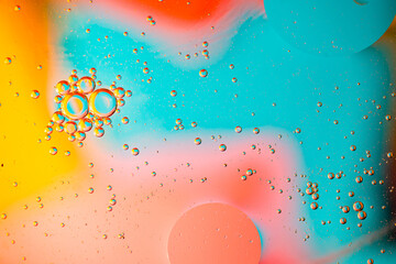 Abstraction of bright bubbles of oil in water. Blurred background, wallpaper.