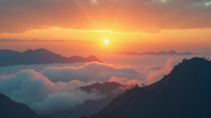 Obraz premium The sun is setting over a mountain range, casting a warm glow over the clouds