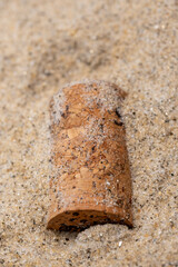 wine cork on the beach sand Macro