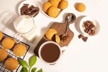 Hot chocolate or coffee espresso with chocolate pieces and cookies.