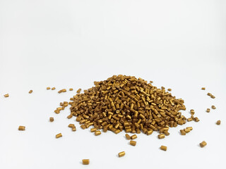 gold masterbatch granules, poured into a white background, polymer overlay carries gold yellowish pigment, as a product catalog banner design for a plastic manufacturing industry company profile