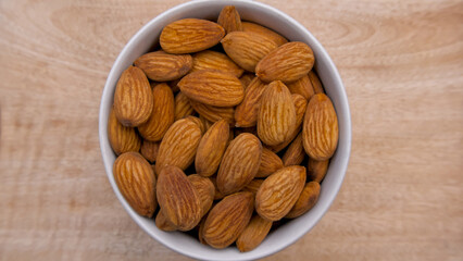Flat Lay of Raw Almonds in a Vibrant White Bowl for Healthy Living and Food