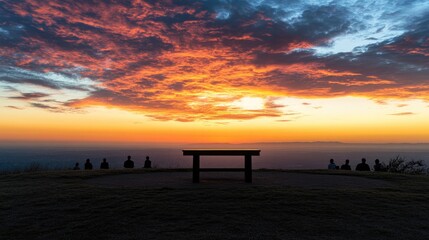 panoramic image of podium on hilltop outdoor setting with dramatic sunset colors and silhouettes of distant people