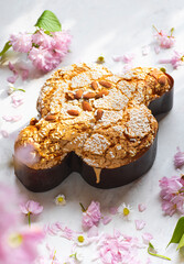 Сolomba pasquale - Italian sweet Easter bread or cake with almonds and powdered sugar and candied...