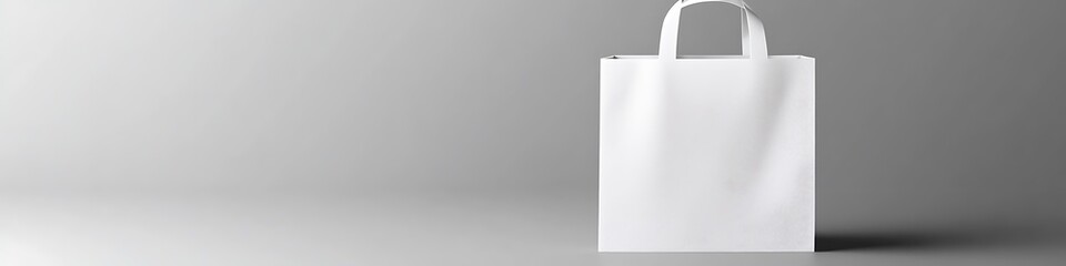 Empty white paper bag mockup with slight shadow and texture visible on a gray background,.