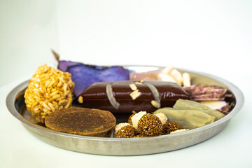 A Plate of jaggery, sesame balls, yam, sweet potato for Maghe Sankranti Festival or Pre Workout Meal
