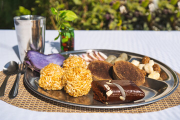 A Plate of jaggery, sesame balls, yam, sweet potato for Maghe Sankranti Festival or Pre Workout Meal