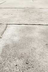 Concrete surface with subtle texture and lines captured in bright daylight showcasing an outdoor setting