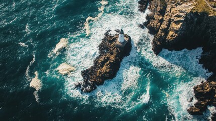 Lighthouse standing resilient on a rocky coastline with crashing waves during daylight