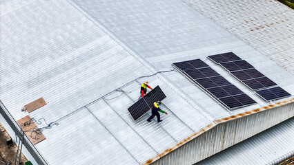 A sustainable energy project featuring solar panels on a roof surrounded by tropical trees, highlighting renewable energy efforts and the integration of green technology into rural areas.