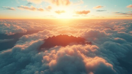 Aerial view of mountain peaks piercing a sea of clouds at sunset.