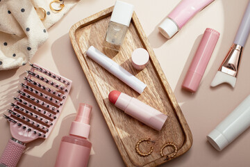 Beauty products background flat lay with skincare, haircare and makeup items on beige