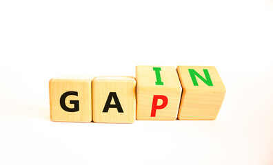 Gain or gap symbol. Concept words Gain Gap on wooden block. Beautiful white table white background. Business gain or gap concept. Copy space.