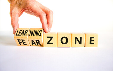 Learning or fear zone symbol. Concept words Learning zone Fear zone on wooden cubes. Beautiful white table white background. Psychologist hand. Business and learning or fear zone concept. Copy space.
