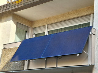 A balcony power station mounted on a railing illuminated by the last rays of sunlight.