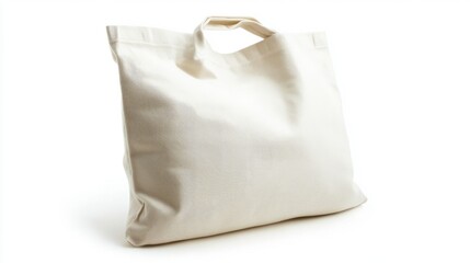Obraz premium Eco-friendly white canvas grocery bag with a textured surface, isolated on white, emphasizing sustainability.