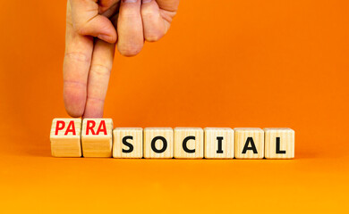 Social or parasocial symbol. Concept words Social or Parasocial on beautiful wooden blocks. Beautiful orange table orange background. Businessman hand. Business social parasocial concept. Copy space.