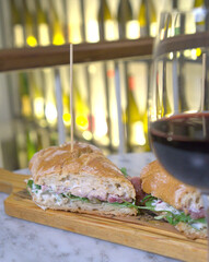  A delectable tuna sandwich served on a rustic wooden board