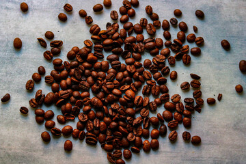 Coffee beans on a marble background. Coffee beans texture.