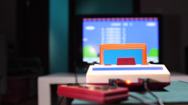 Old video game console running, displaying a platform game on a crt tv