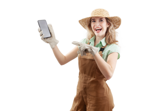 Smiling woman wearing an apron, hat, and gloves for gardening, isolated on white background, points at a smartphone. Online gardening shopping in a web store for the arrival of spring and garden work - Powered by Adobe