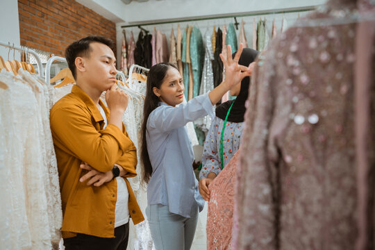 A fashionable consultation session is happening in a boutique, discussing various styling options - Powered by Adobe