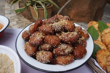 Loukoumades sprinkled with grated walnut, greek sweets
