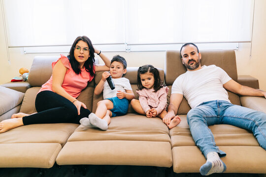 Family watching movie on couch