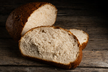 Sliced bread on wooden background.