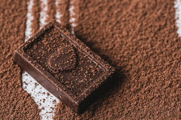 Closeup chocolate bar and cocoa powder on white background.