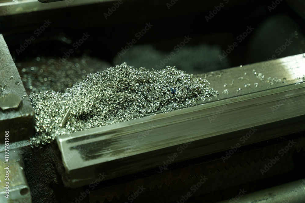 Poster shimmering metal shavings scatter across a lathe at a bustling workshop