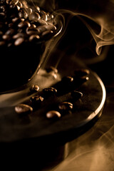Close-up examination of fresh coffee beans revealing rich texture against a dark backdrop with gentle smoke
