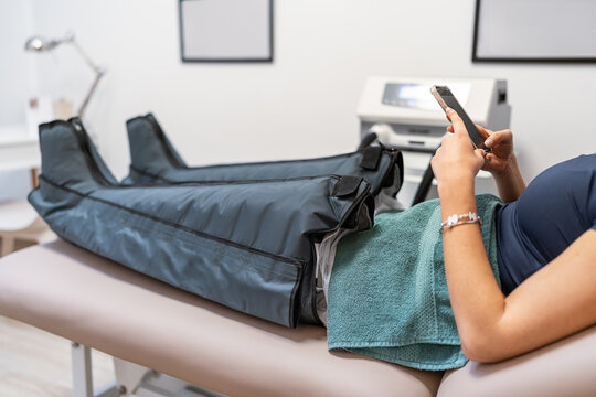 Woman in pressotherapy leg machine.