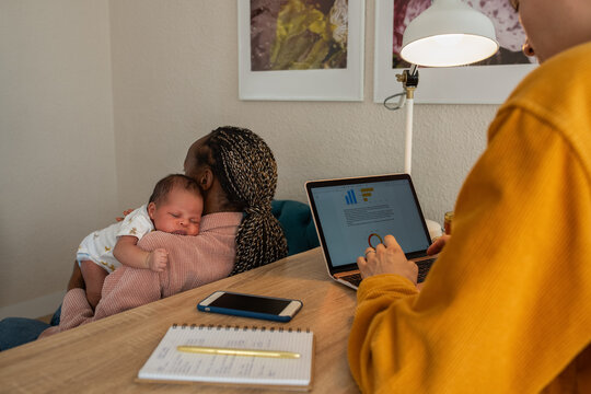 Woman holding sleeping baby