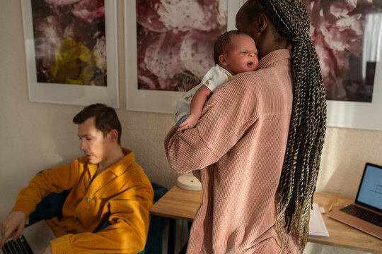 Mother holding baby over shoulder to burp