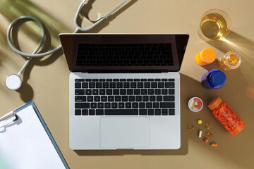 Medical Office Desk with Laptop, Pills, and Stethoscope