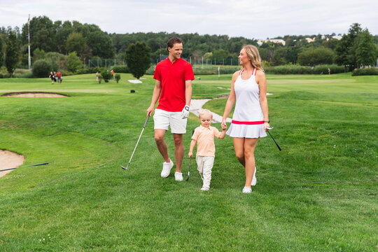 Family Walking with Young Son in Golf Field